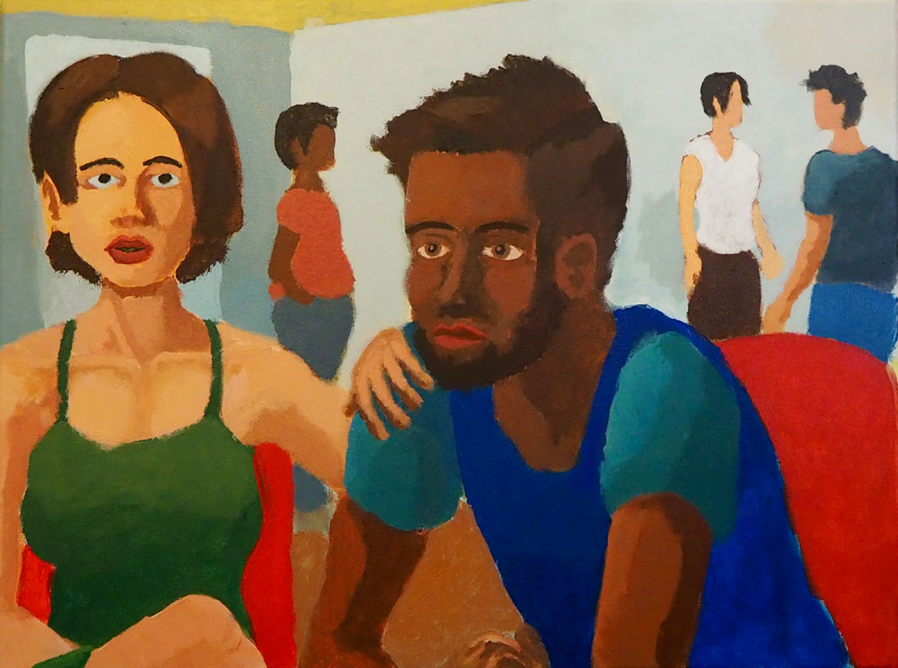 A seated couple in red chairs in a small room